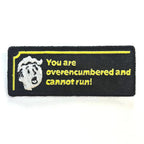 Embroidered patch with text 'You are overencumbered and cannot run!' on a black background